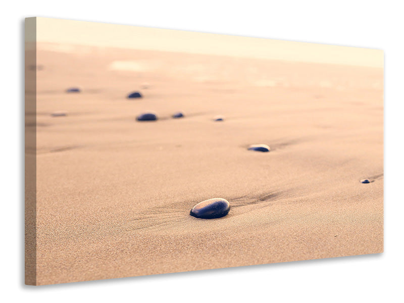 Leinwandbild Kiesel im Sand